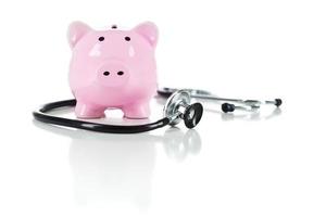 Piggy Bank and Stethoscope Isolated on White photo