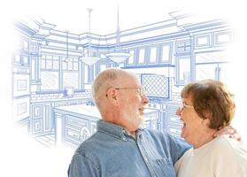 Senior Couple Over Custom Kitchen Design Drawing on White photo