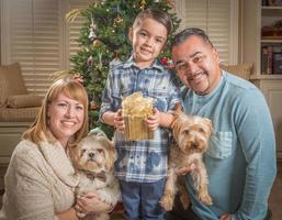 Young Mixed Race Family In Front of Christmas Tree photo