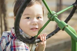 Mixed Race Young Boy Playing on Tractor photo