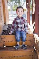 Cute Young Mixed Race Boy Having Fun on Railroad Car photo