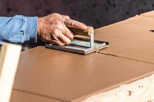 Construction Worker Using Hand Groover On Wet Cement Forming Coping Around New Pool photo