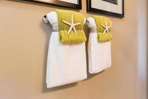 Beautiful Star Fish Decor Detail of Towels Hanging In Bathroom photo