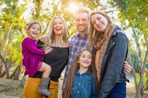 Mixed Race Family Members Having Fun Outdoors photo