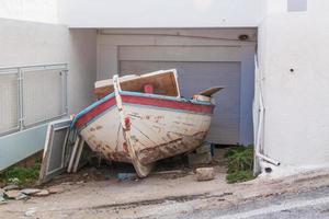 Rundown Boat In Storage At Home in Santorini Greece photo