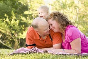 Affectionate Couple with Son in Park photo