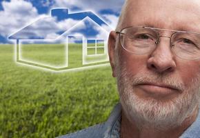 Melancholy Senior Man with Grass Field and Ghosted House Behind photo