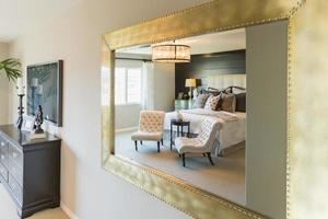 Beautiful Bedroom Reflection in Decorative Mirror. photo