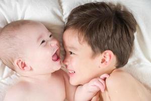 Mixed Race Chinese and Caucasian Baby Brothers Having Fun Laying on Their Blanket photo