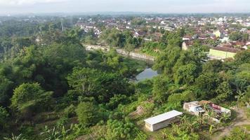 Aerial view of Moyudan bridge, Godean road, Special Region of Yogyakarta with trees and houses in the background photo