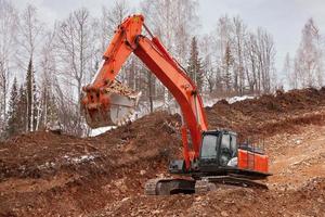 excavator at work in the forest photo