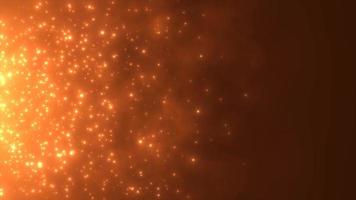 Abstract orange fiery flame bonfire of particles and sparks glowing beautiful magical on a dark background. Abstract background. Video in high quality 4k, motion design