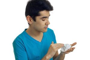 close-up portrait of a guy in a t-shirt which seriously impair shaving foam on hand photo