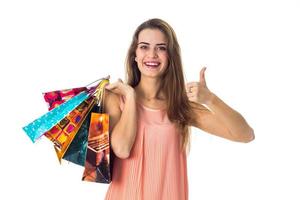 beautiful girl holding a shopping packages and shows class photo