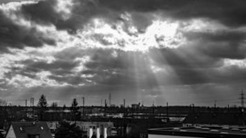 Dramatic cloud formations with sunbeams over city of Darmstadt in Germany photo