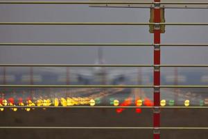 Security fence at an airport with airplane in background photo