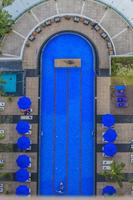 Top view on a blue colored swimming pool with sunchairs photo