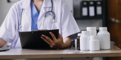 Homecare nursing service and elderly people cardiology healthcare. Close up of young hispanic female doctor nurse check mature caucasian man patient heartbeat using stethoscope during visit photo