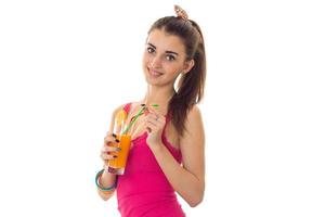 beautiful young girl in a bright pink t-shirt smiles and keeps the juice photo