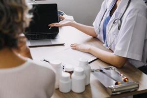 Homecare nursing service and elderly people cardiology healthcare. Close up of young hispanic female doctor nurse check mature caucasian man patient heartbeat using stethoscope during visit photo