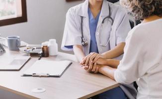 Homecare nursing service and elderly people cardiology healthcare. Close up of young hispanic female doctor nurse check mature caucasian man patient heartbeat using stethoscope during visit photo