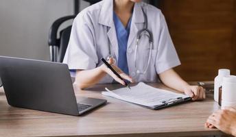 Homecare nursing service and elderly people cardiology healthcare. Close up of young hispanic female doctor nurse check mature caucasian man patient heartbeat using stethoscope during visit photo