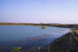 Crystal clear blue water lake landscape view nearby Padma river in Bangladesh photo