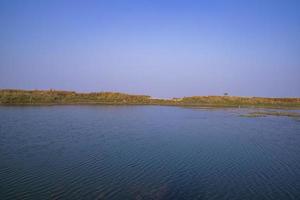 Crystal clear blue water lake landscape view nearby Padma river in Bangladesh photo