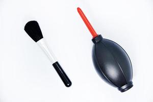 Tools for cleaning photo optics. Pneumatic pear brush on a white background. Camera cleaning kit.