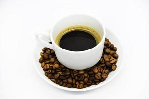 Porcelain coffee cup on a white background. Delicious coffee in a cup and coffee beans. photo