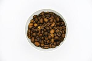 Toasted coffee beans in a porcelain cup. Coffee mixture. Delicious coffee beans and freeze-dried. photo