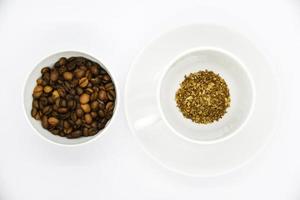 Toasted coffee beans in a porcelain cup. Coffee mixture. Delicious coffee beans and freeze-dried. photo