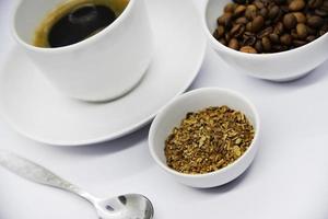 Porcelain coffee cup on a white background. Delicious coffee in a cup and coffee beans. Instant coffee and coffee beans close-up. photo