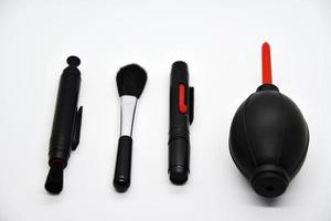 Tools for cleaning photo optics. Pneumatic pear brush on a white background. Camera cleaning kit.