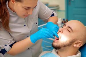 foto horizontal del paciente en el examen de los dientes en el dentista