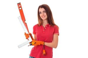 cheerful brunette woman builder makes renovation isolated on white background photo