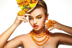 Horizontal portrait of young girl with beautiful makeup and rowanberry accessories photo