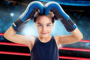 Charming little girl in boxing gloves photo