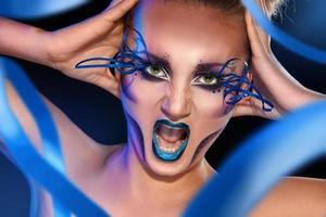 adult female screaming on camera with creative make up face photo