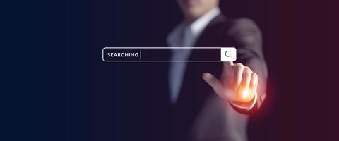 Businessman hand searching information on internet, Data search engine Optimization concept. Man's finger browsing internet connecting worldwide photo
