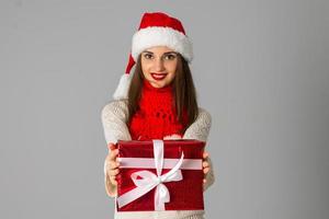 girl in santa hat with gift photo