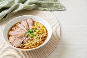 egg noodles with stewed duck in brown soup photo