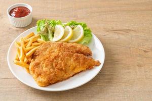 Homemade Breaded Weiner Schnitzel with Potato Chips photo