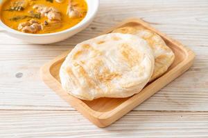 Chicken curry soup with roti photo