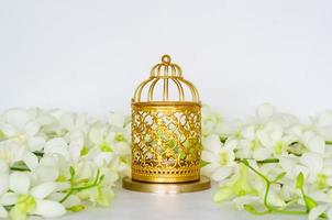 Golden lantern with white orchid flower for the Muslim feast of the holy month of Ramadan Kareem. photo