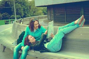 tourists resting on a bench photo