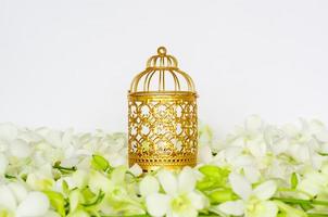 Golden lantern with white orchid flower for the Muslim feast of the holy month of Ramadan Kareem. photo