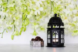 Lantern and dates fruit with orchid flower on white background for the Muslim feast of the holy month of Ramadan Kareem. photo
