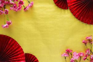 Chinese new year background concept with red oriental fans and cherry blossom on gold empty space background. photo