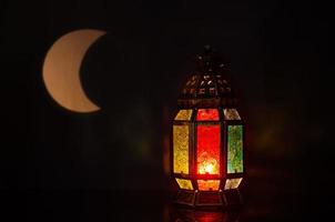 Lantern with moon shape from light on background for the Muslim feast of the holy month of Ramadan Kareem. photo